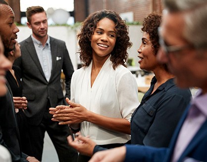 Group of people in business clothing chatting at event
