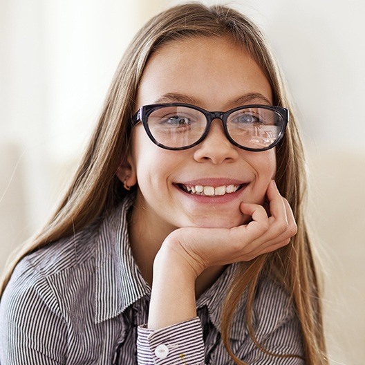 Young girl sharing healthy smile after children's dentistry checkup