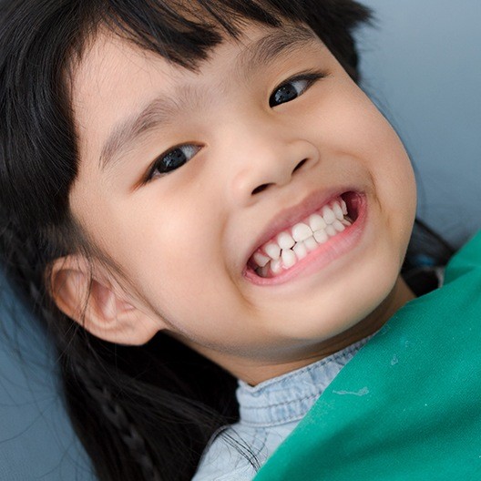 Child sharing smile after fluoride treatment