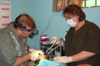 Dentist and dental team member treating patient