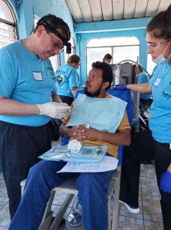 Dentist talking to patient during community event
