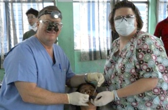 Dentist and team member treating dental patient