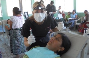 Dental team member smiling with dental patient