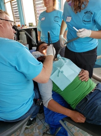 Group of dental team members caring for dental patient