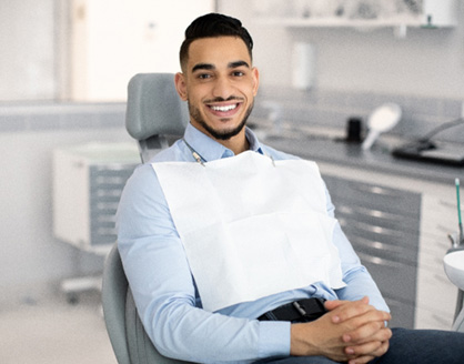 Patient smiling while sitting in treatment chair