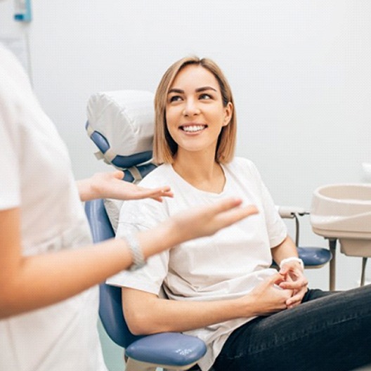 woman talking to her cosmetic dentist in Arlington, TX