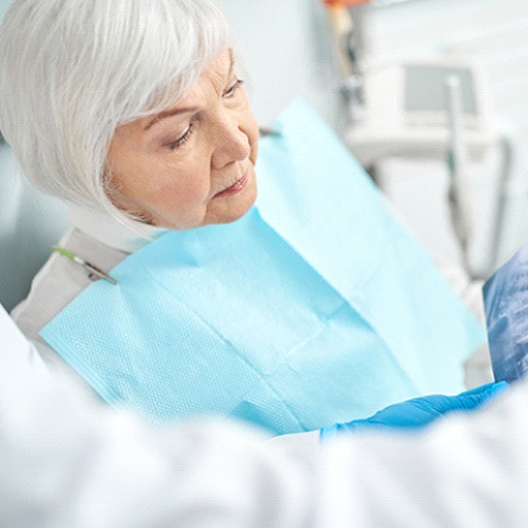 a dentist showing a patient their X-rays