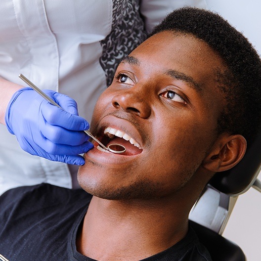 Man receiving dental checkup to prevent dental emergencies