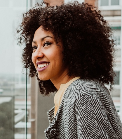 Woman sharing healthy smile after preventive dentistry