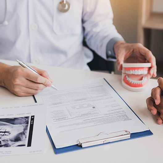 Dentist reviewing dental treatment plan with patient