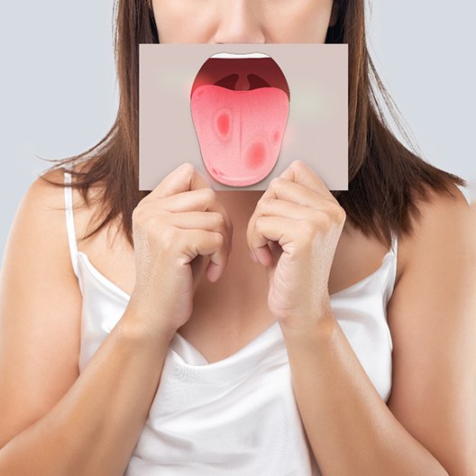 a woman showing symptoms of oral cancer in Arlington