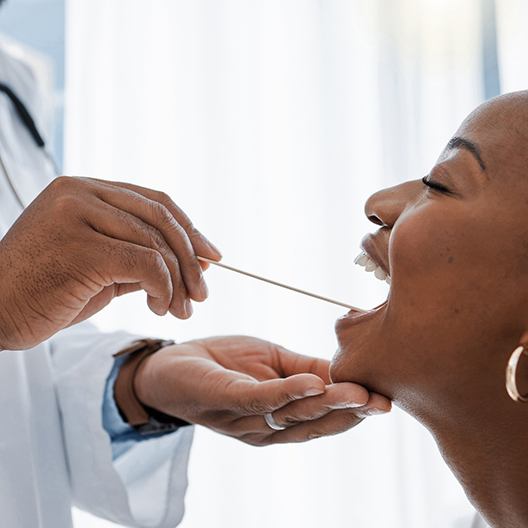 a patient undergoing an oral cancer screening in Arlington