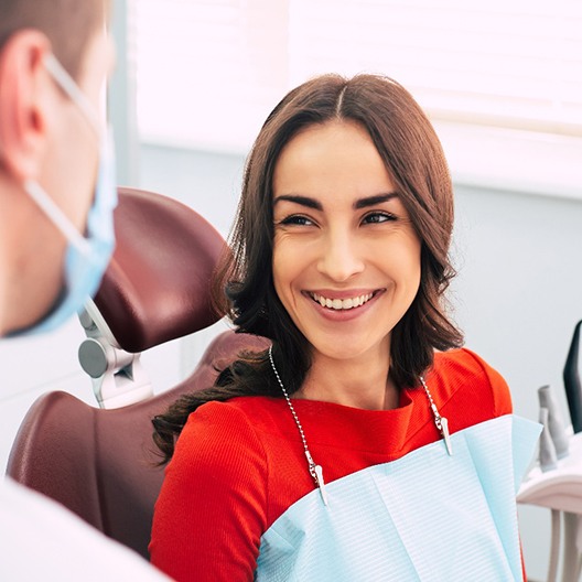 a patient smiling at her dentist in Arlington