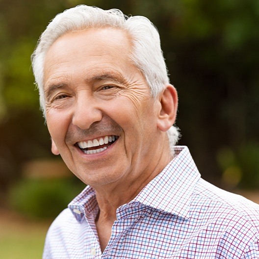 Man sharing smile after dental crown restoration