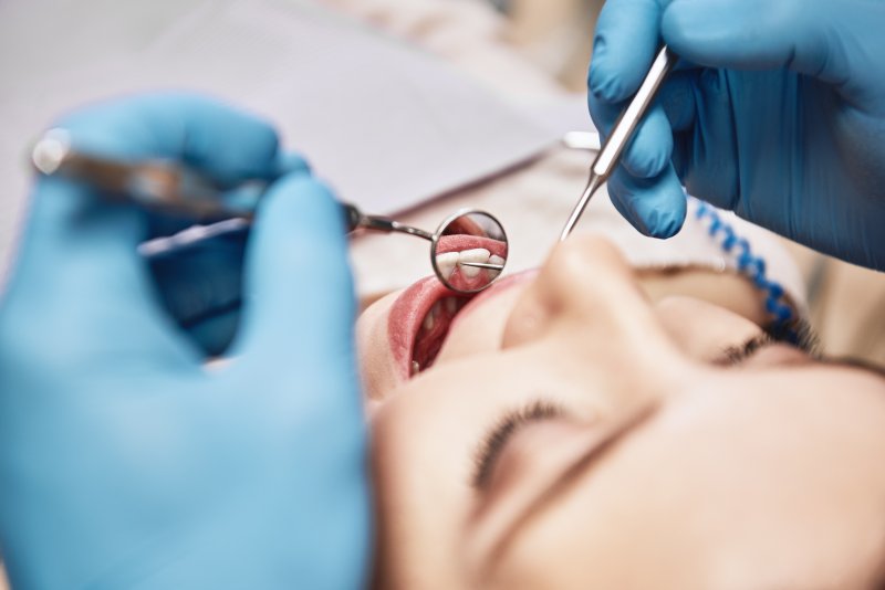 dentist examining mouth during checkup