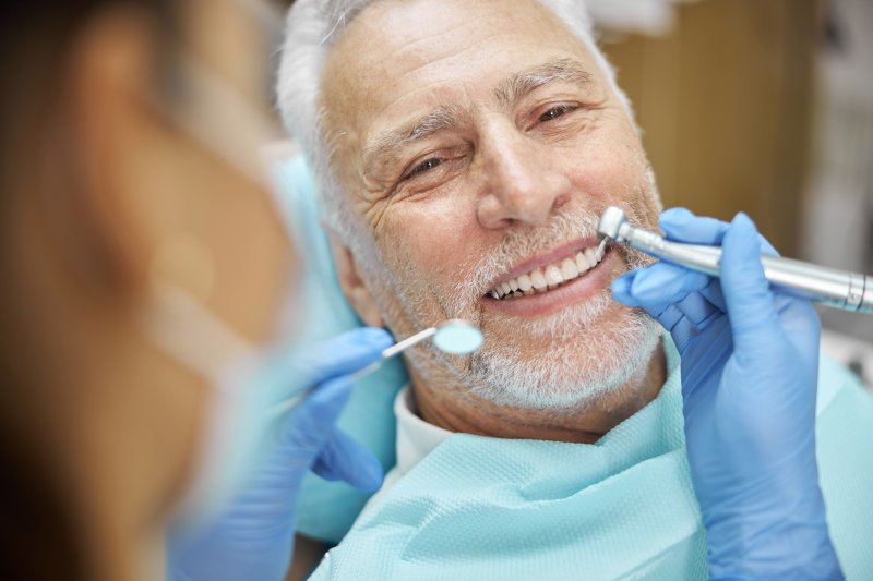 Senior receiving dental care from a cosmetic dentist