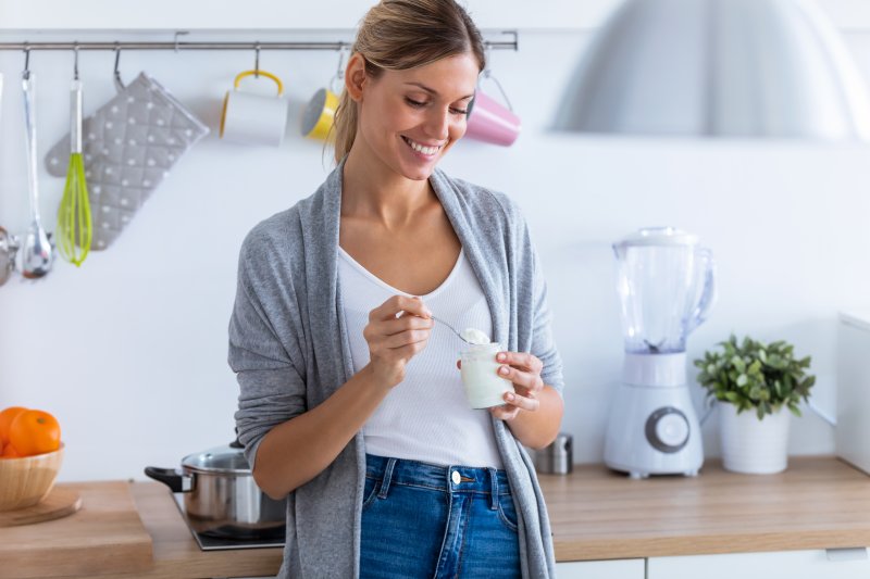 woman eating plain yogurt