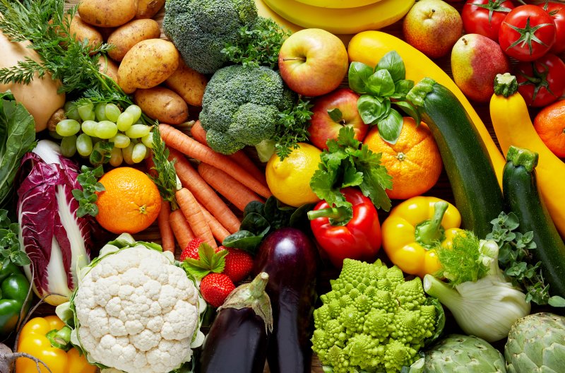 A zoomed-in spread of various fresh vegetables and fruits of different colors